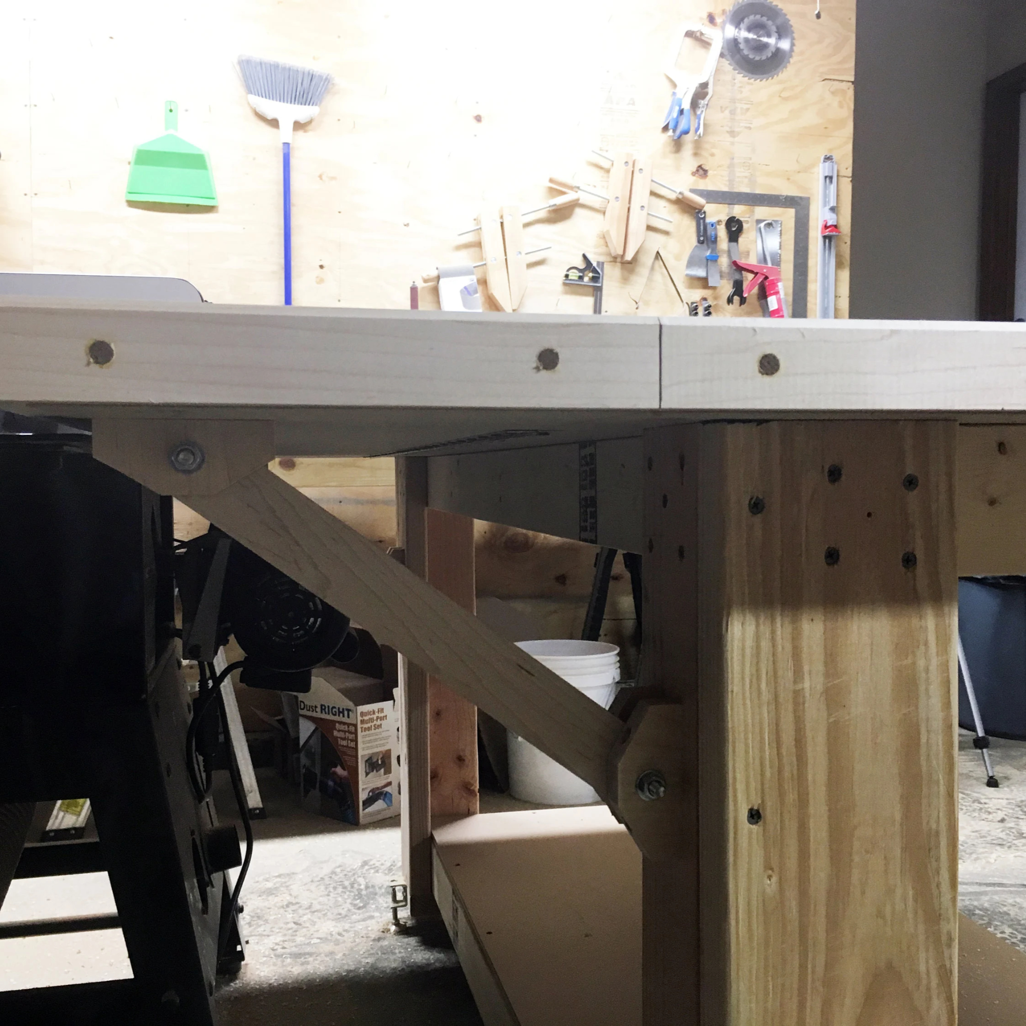 Close-up of the leg brace joinery on the assembly outfeed table