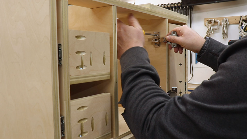 Attaching the hinges to the cabinet