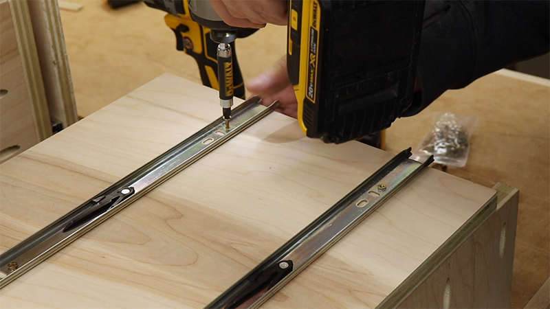 Fastening the drawer slide to the pull out tray