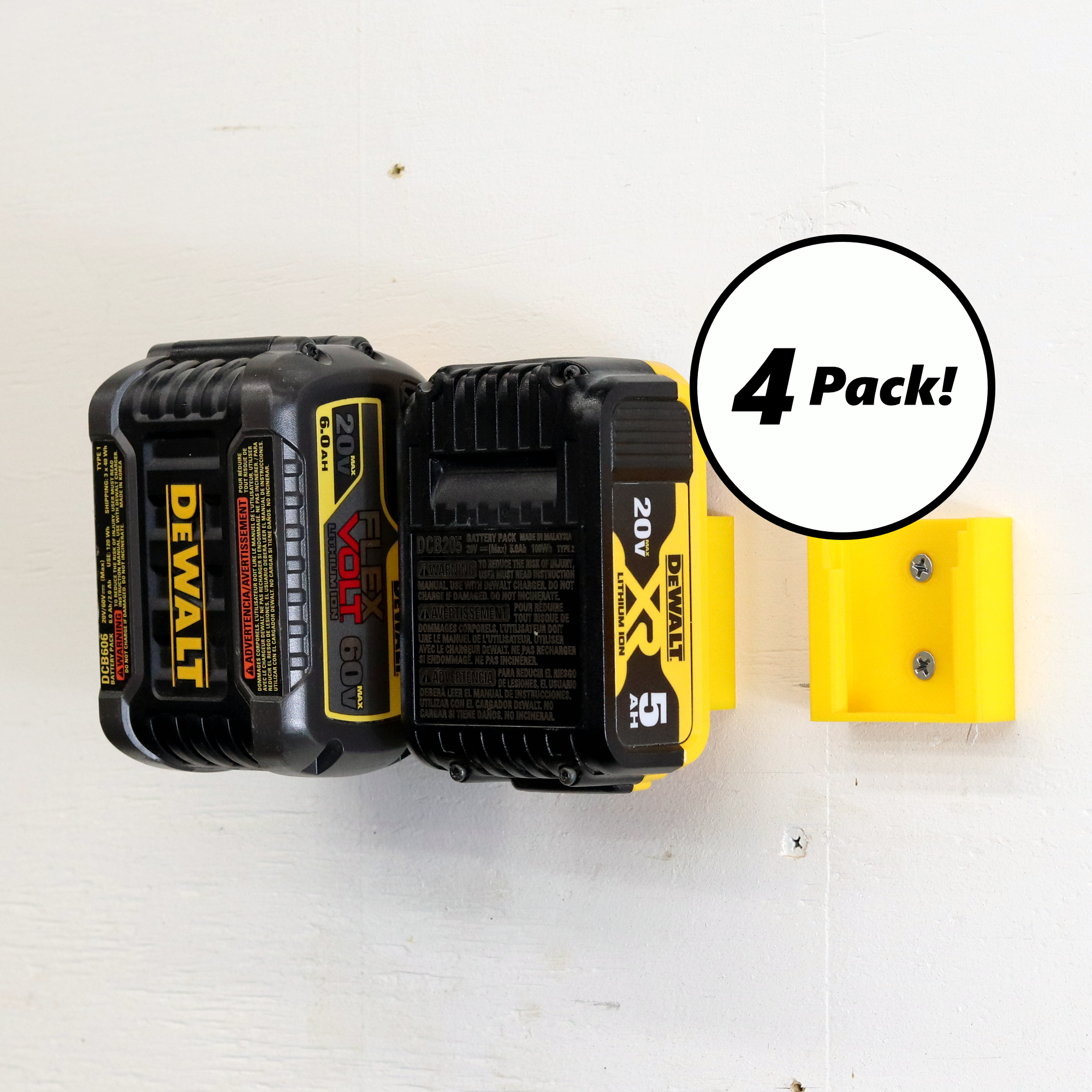 Four DeWalt battery holders mounted on a wall, each holding a 20V/60V FlexVolt battery