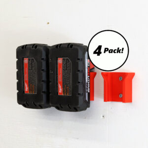 Four Milwaukee battery holders mounted on a wall, each holding a M18 battery