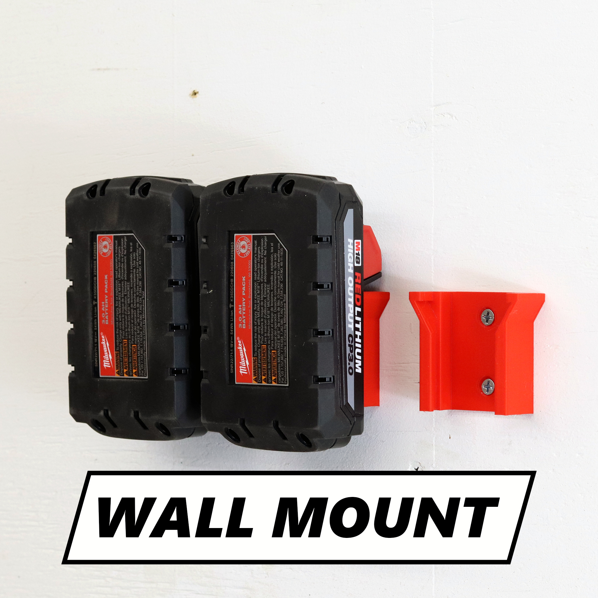 Milwaukee battery holder mounted on a shop wall holding a M18 battery