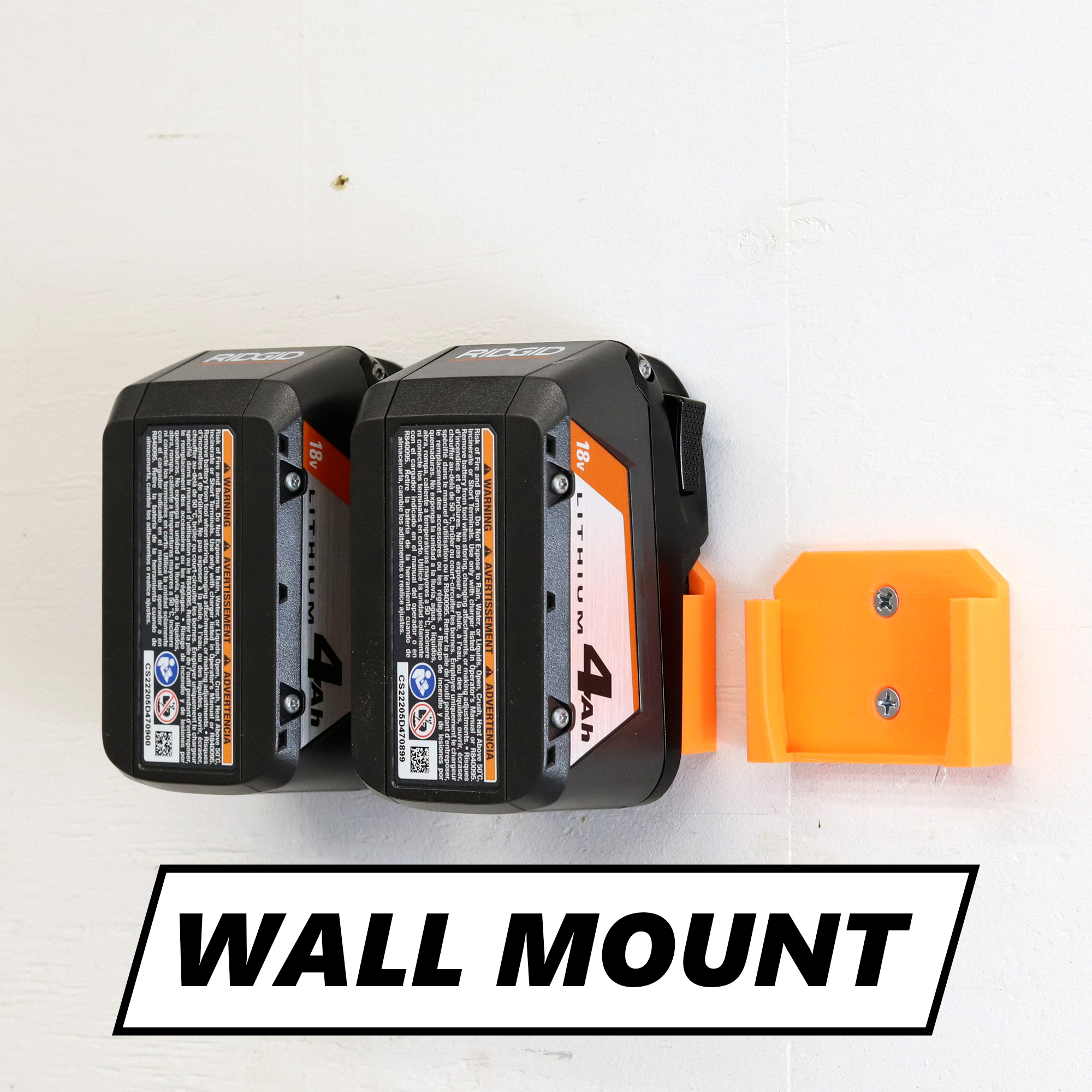 Ridgid battery holder mounted on a shop wall holding a 18V battery