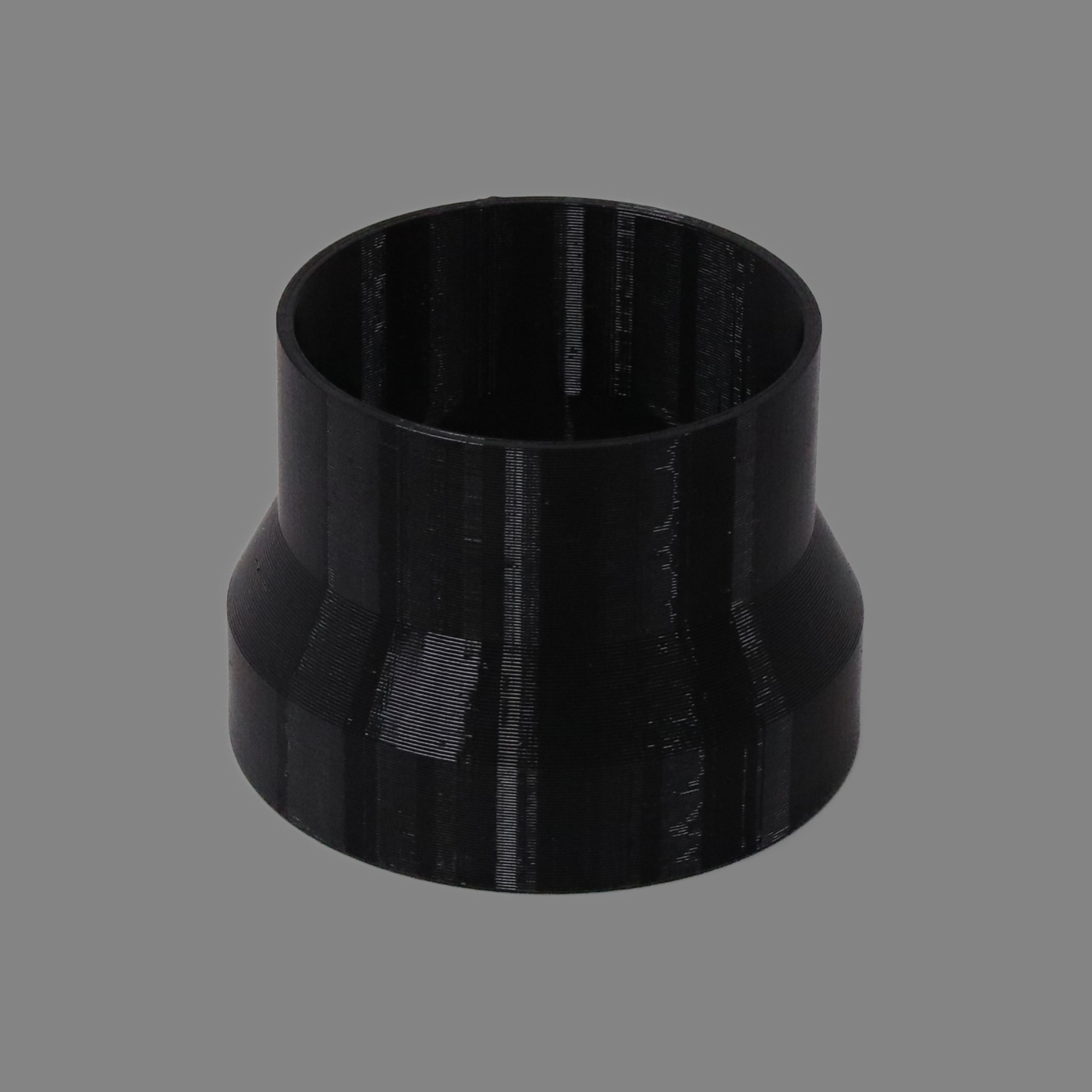 Black 3D printed PETG dust collection adapter connecting 4 inch SDR35 PVC to 4 inch flex hose, alternate angle product photo