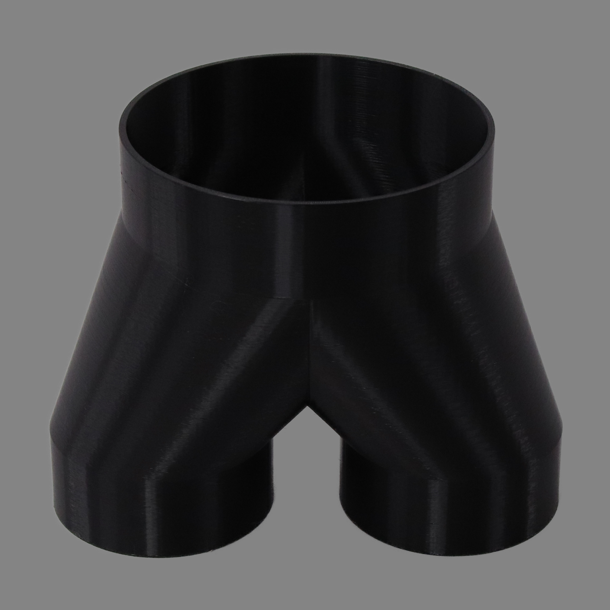 Black 3D printed PETG dust collection adapter connecting 6 inch flex hose to dual 4 inch flex hose outlets, alternate angle product photo