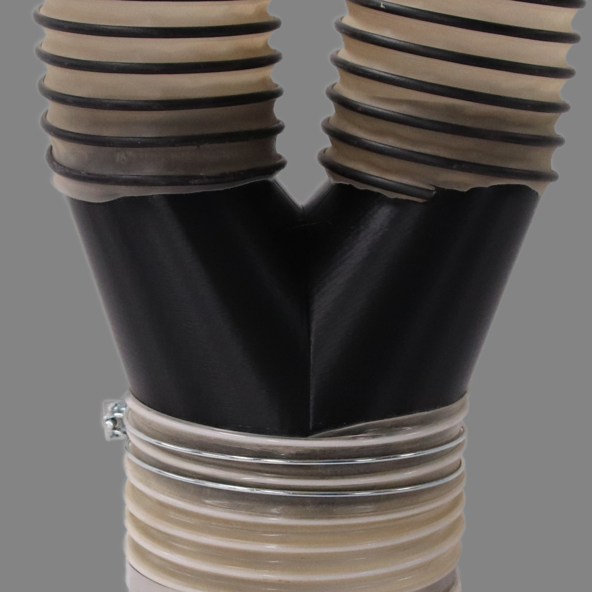 Black PETG dust collection adapter connecting 6 inch flex hose to dual 4 inch flex hose outlets, shown installed in a shop dust collection hose line