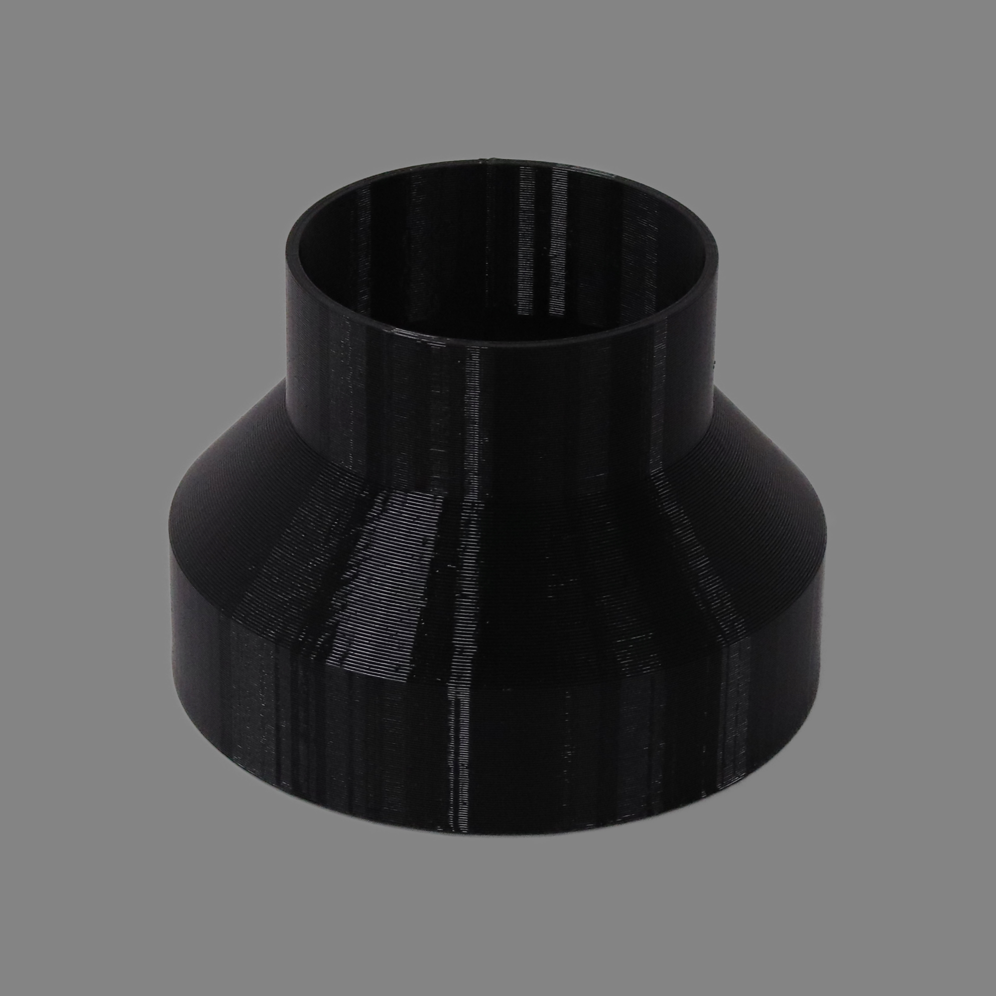 Black 3D printed PETG dust collection adapter connecting 6 inch flex hose to 4 inch flex hose, alternate angle product photo