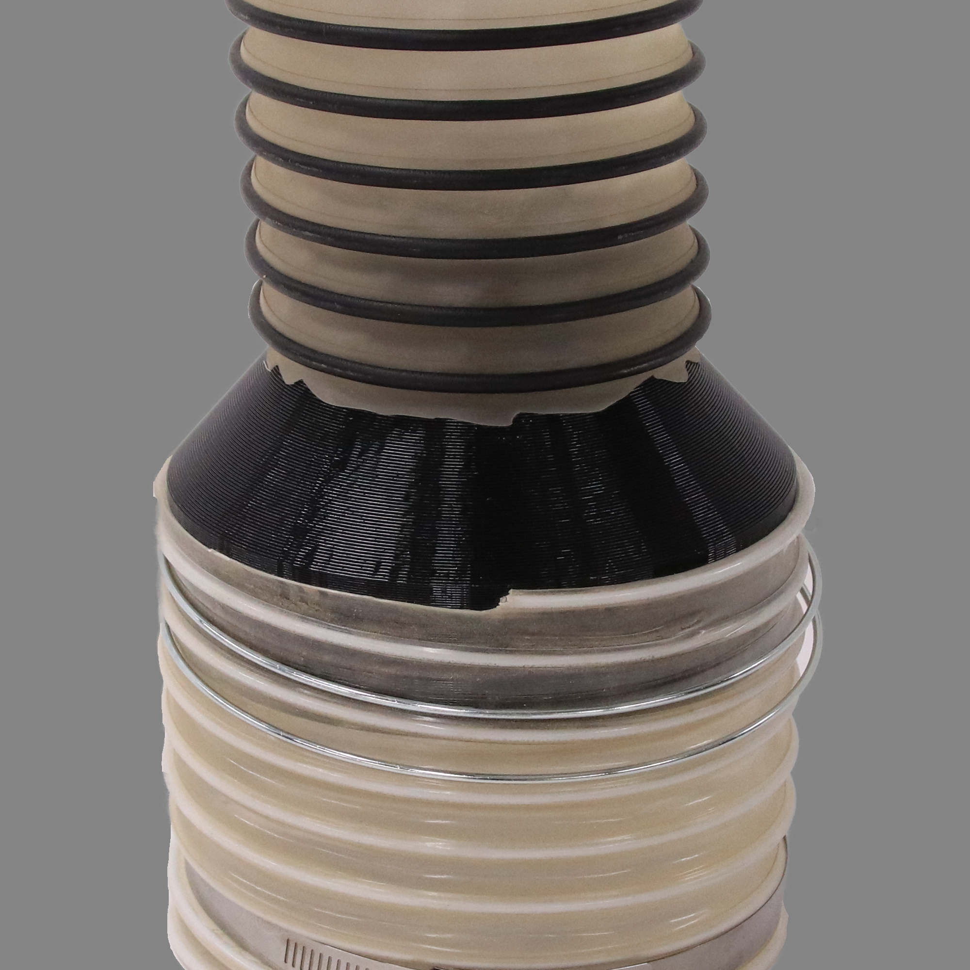 Black PETG dust collection adapter connecting 6 inch flex hose to 4 inch flex hose, shown installed in a shop dust collection hose line