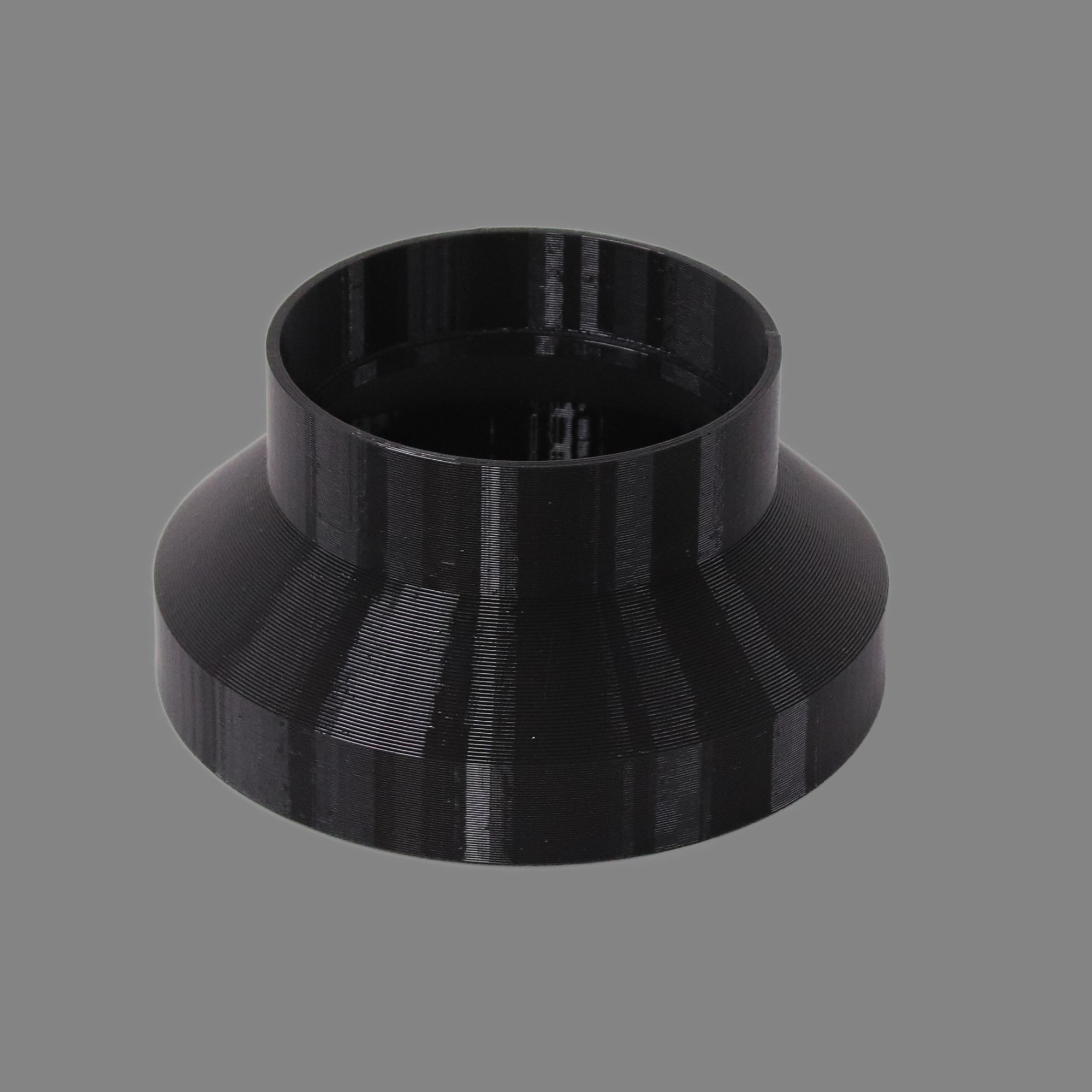 Black 3D printed PETG dust collection adapter connecting 6 inch SDR35 PVC to 4 inch SDR35 PVC, alternate angle product photo