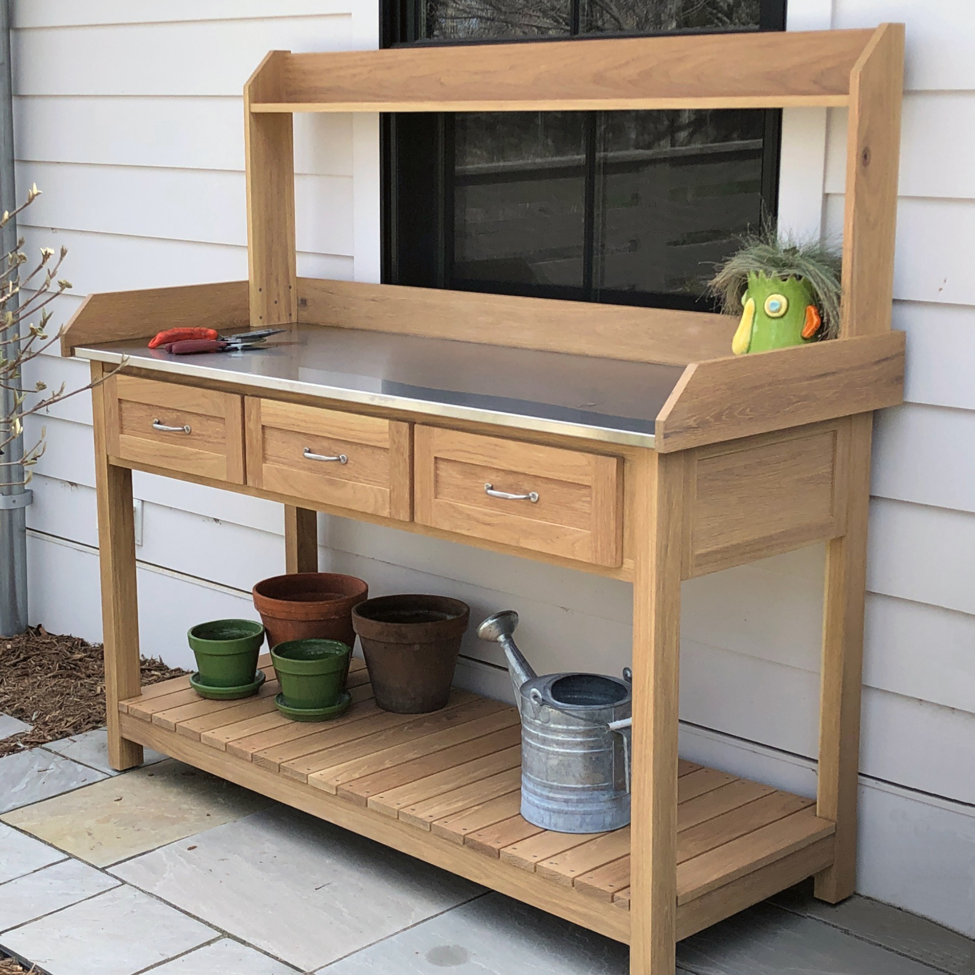 Angled view of a DIY potting bench with hutch and drawers