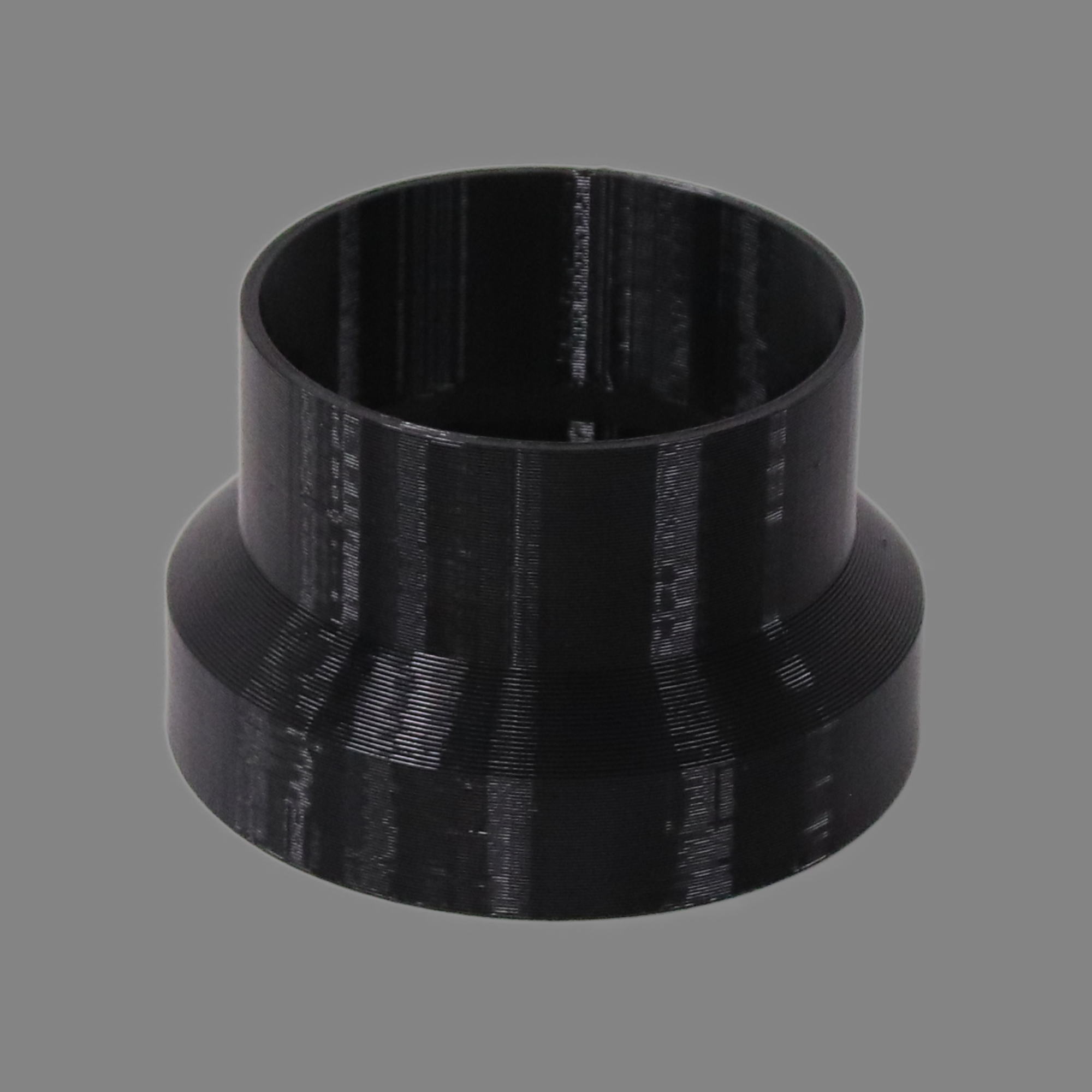 Black 3D printed PETG dust collection adapter connecting 4 inch SCH40 PVC to 4 inch flex hose, alternate angle product photo