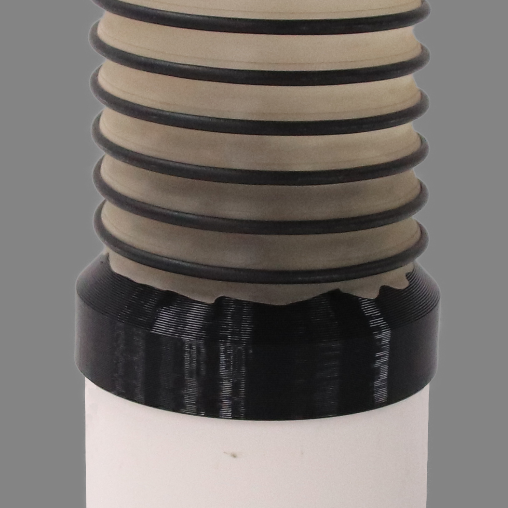 Black PETG dust collection adapter connecting 4 inch SCH40 PVC to 4 inch flex hose, shown installed in a shop dust collection hose line