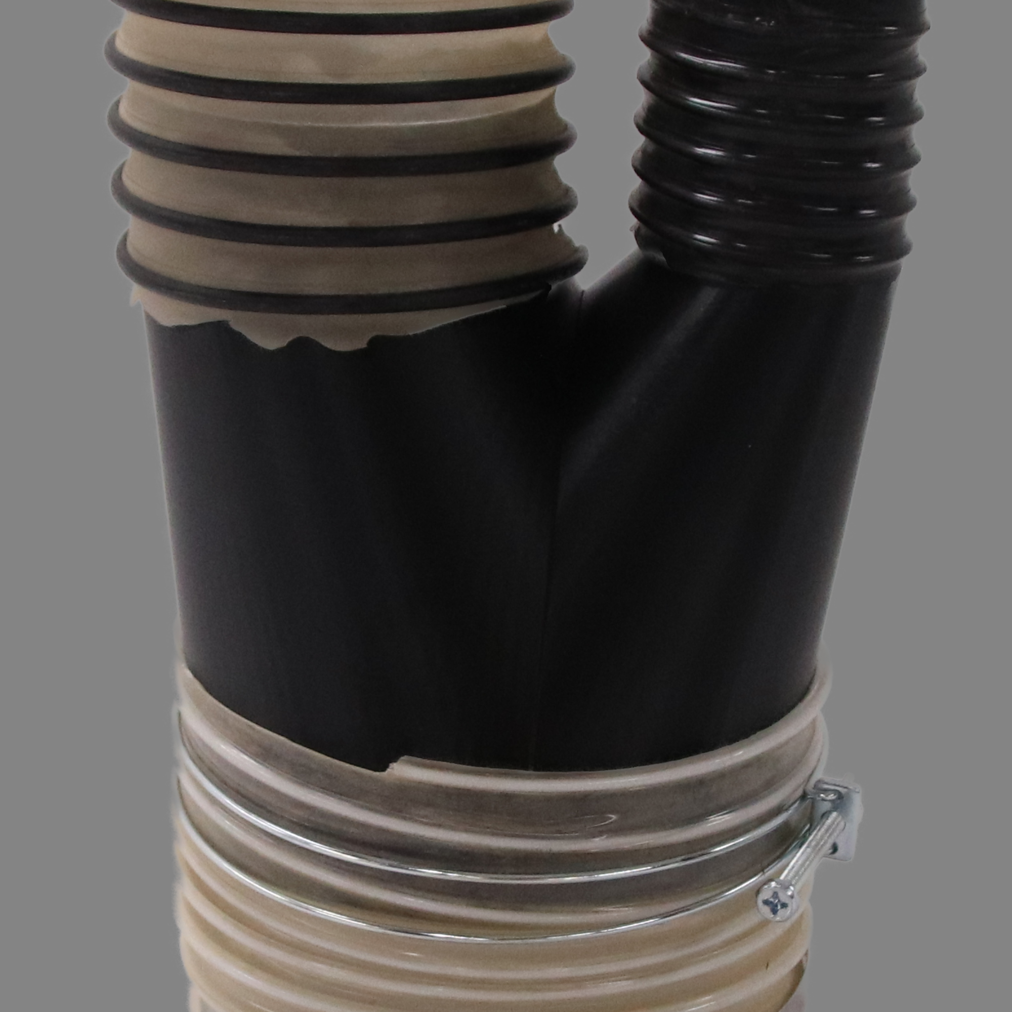 Black PETG dust collection adapter connecting 6 inch flex hose to dual 4 inch and 2.5 inch flex hose outlets, shown installed in a shop dust collection hose line