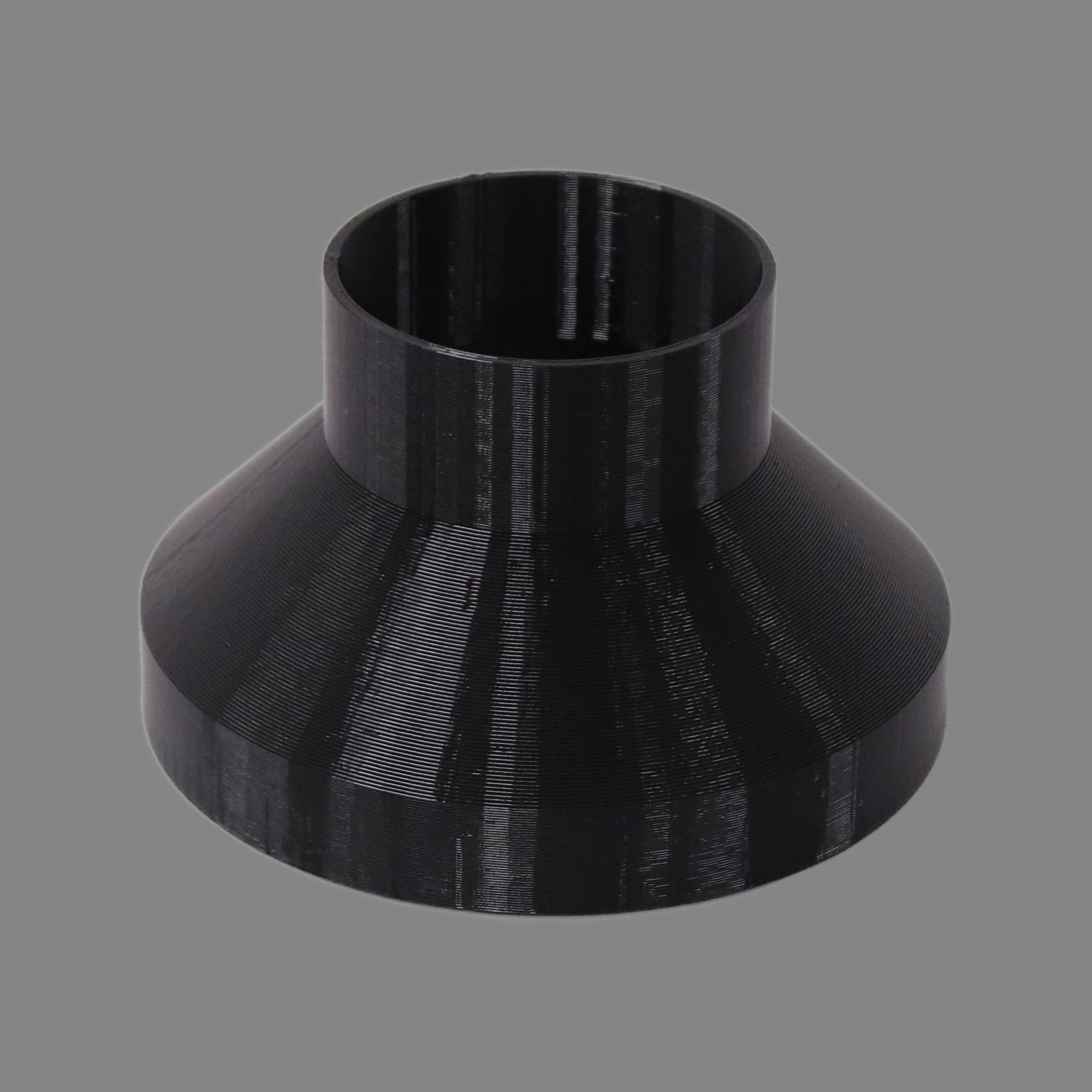 Black 3D printed PETG dust collection adapter connecting 6 inch SCH40 PVC to 4 inch flex hose, alternate angle product photo