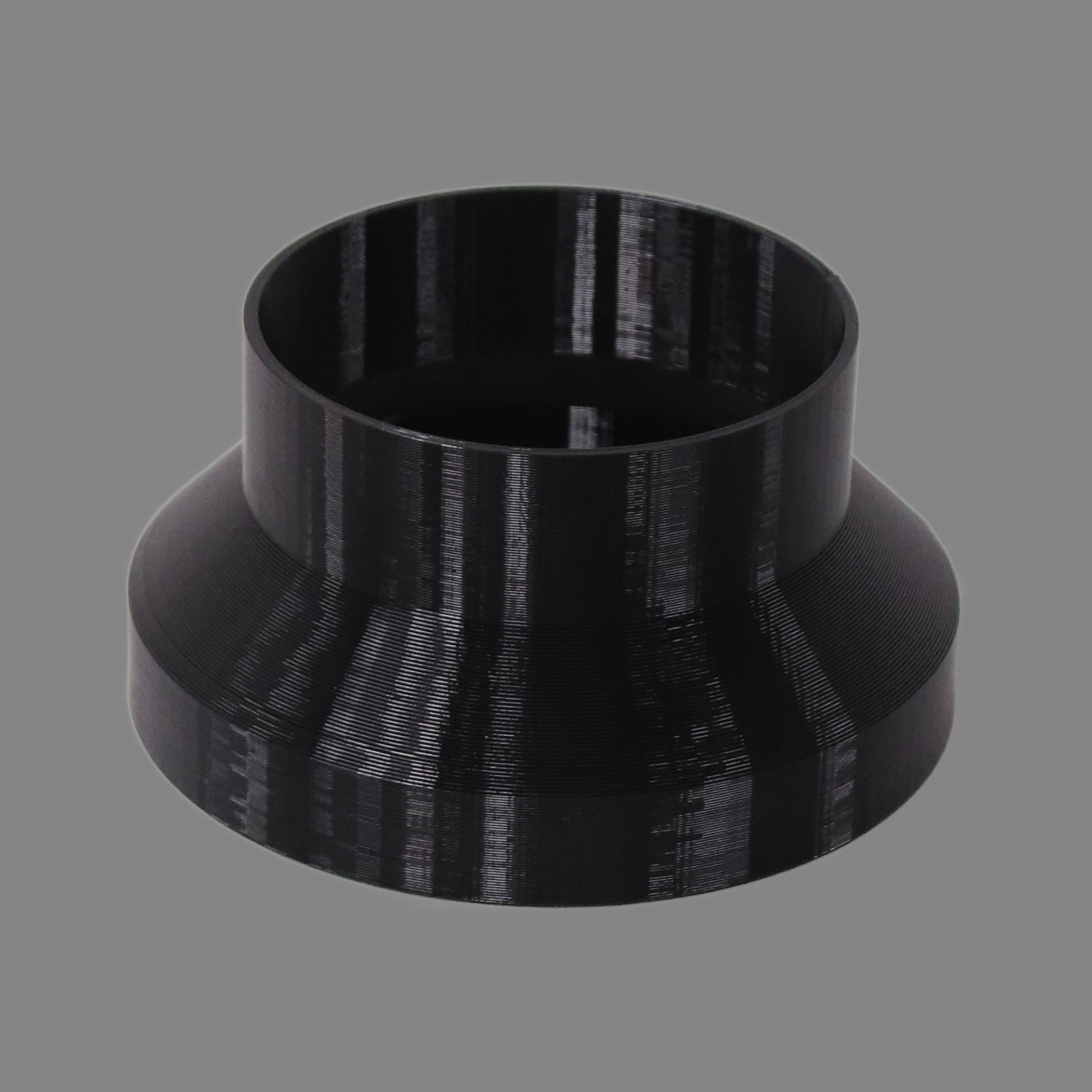 Black 3D printed PETG dust collection adapter connecting 6 inch SCH40 PVC to 5 inch flex hose, alternate angle product photo
