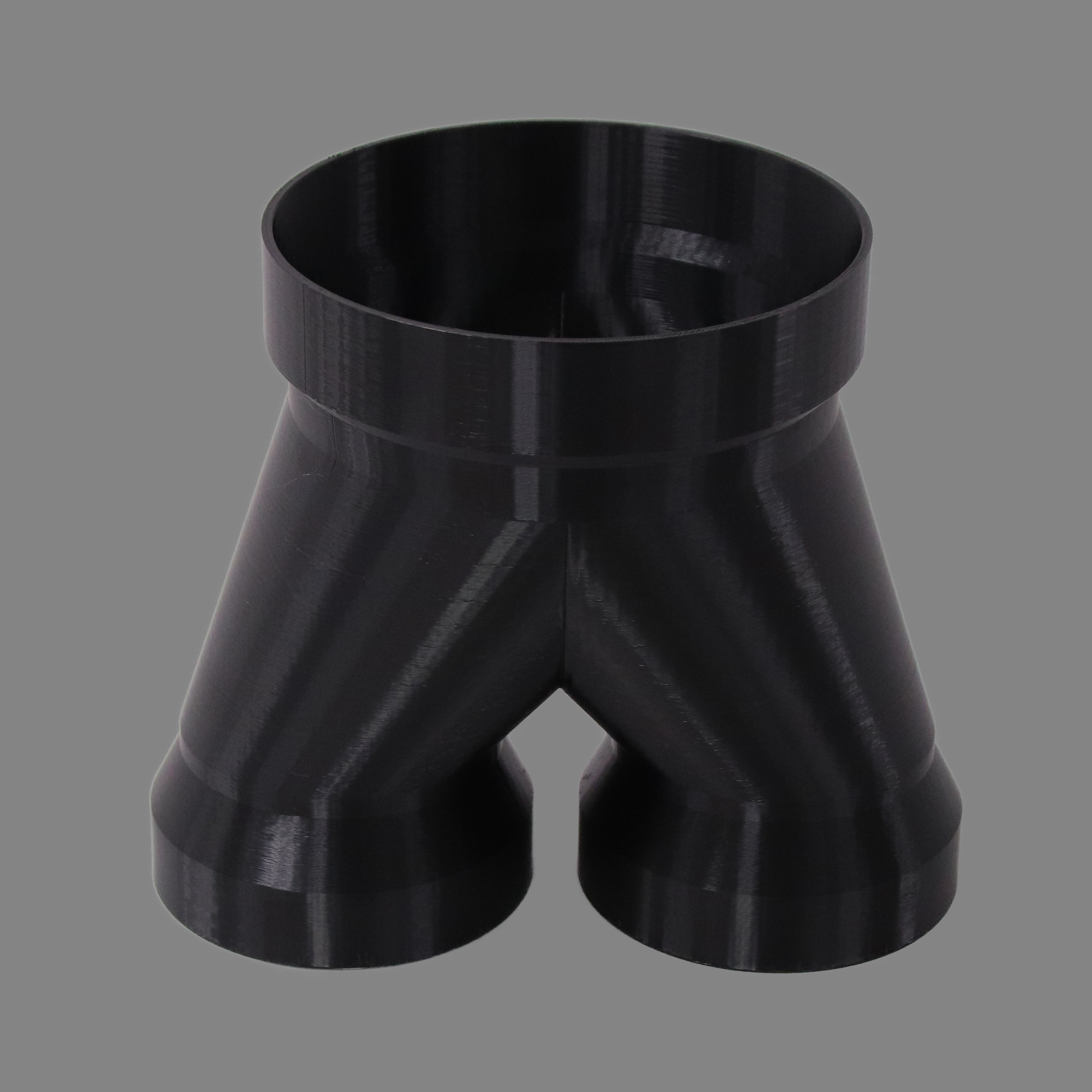 Black 3D printed PETG dust collection adapter connecting 6 inch SDR35 PVC to dual 4 inch SDR35 PVC outlets, alternate angle product photo